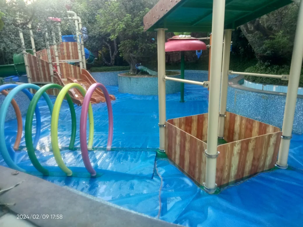Swimming pool water park equipment including slides, water fountains, and play accessories